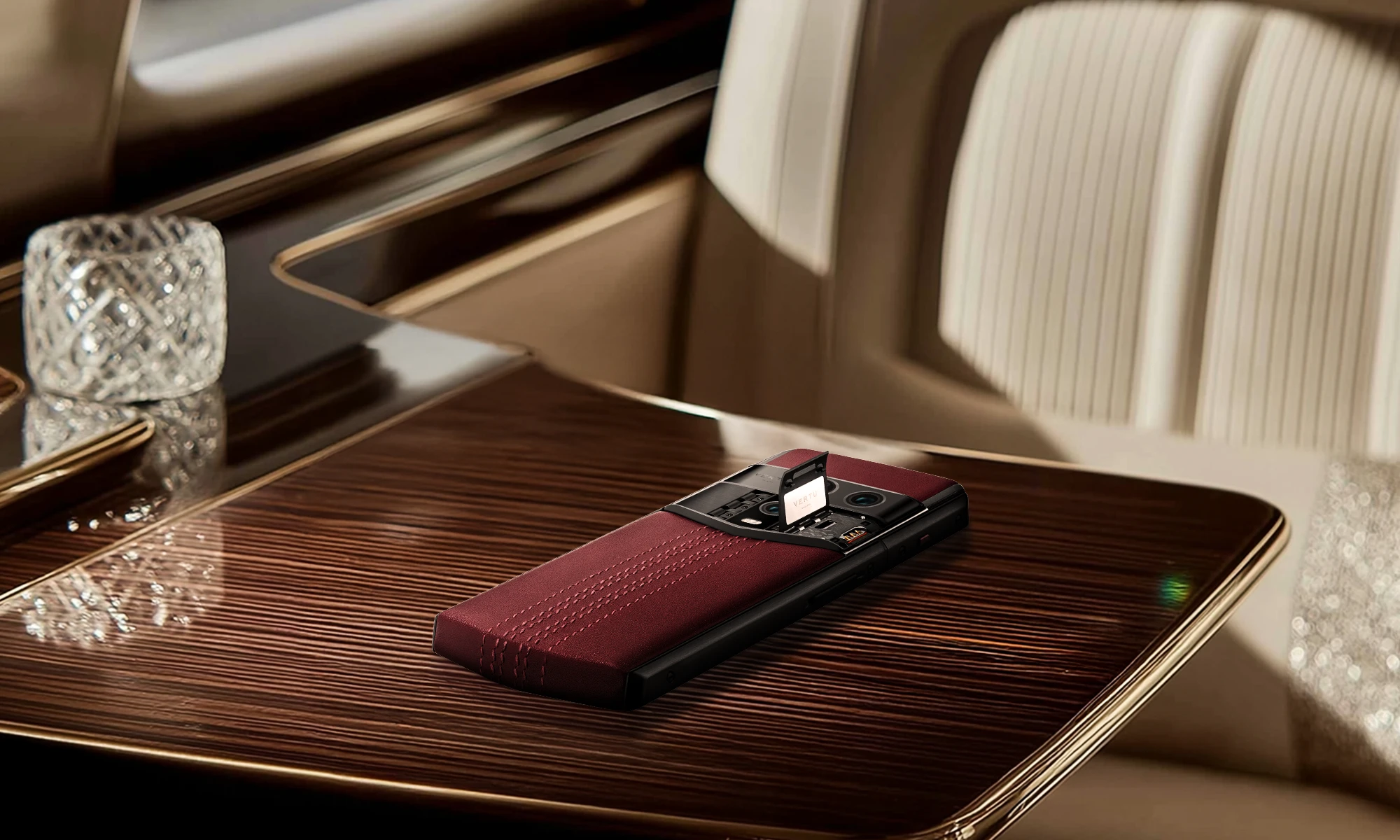 Luxury Vertu smartphone on private jet desk representing secure communications